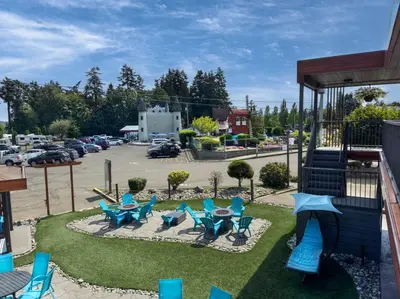 a patio with chairs and tables in a parking lot at The Tide's Inn in Parksville