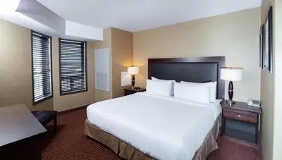 a large white bed in a hotel room at Pomeroy Hotel Fort St. John in Fort Saint John