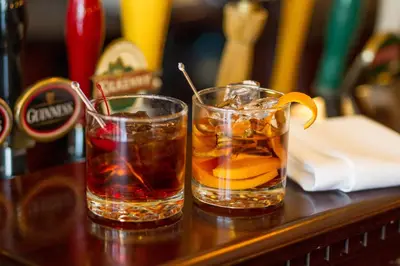 two drinks sitting on a table with at Pomeroy Hotel Fort St. John in Fort Saint John