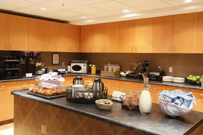 a kitchen with a counter with food on it at Pomeroy Inn & Suites Fort St. John in Fort Saint John
