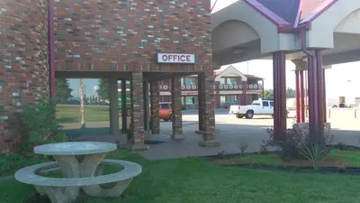 a brick building with a coffee sign on it at Stampeder Inn in Ponoka