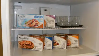 a refrigerator with some food inside of it at Stampeder Inn in Ponoka