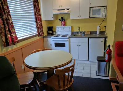 a kitchen with a table and a table and chairs at The Bulldog Hotel in Silver Star
