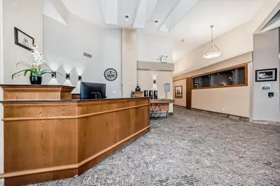 a lobby of a hospital with a reception desk at Stony Plain Inn & Suites in Stony Plain