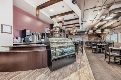a fast food restaurant with a counter and tables at Stony Plain Inn & Suites in Stony Plain