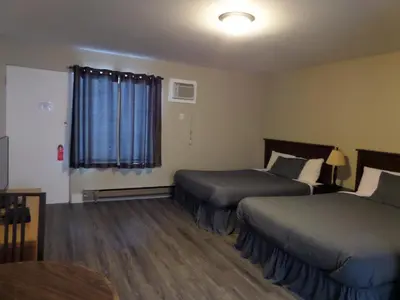 a hotel room with two beds and a window at Ray Lyn Motel in Trail