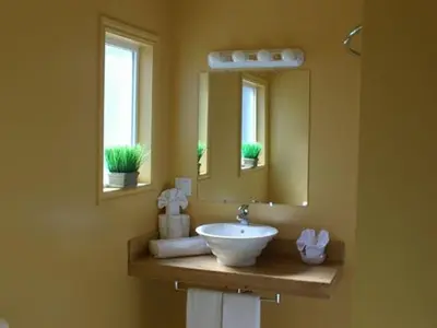 a bathroom with a sink and a mirror at Reynolds Hotel in Lillooet