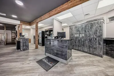 a lobby with a reception desk in a building at Invermere Inn & Suites in Invermere