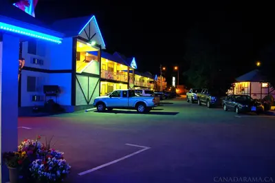 a truck parked in a parking lot in front of a building at Rosedale Motel in Summerland