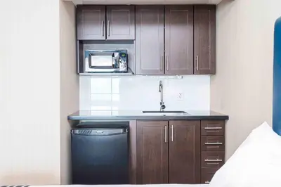 a small kitchen with a sink and a microwave at Sandman Inn Blue River in Blue River