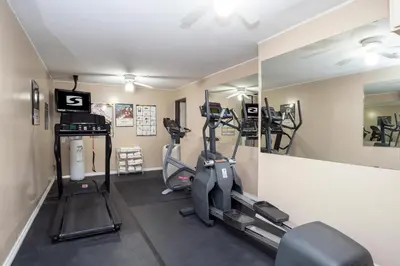 a gym with two tread machines and a mirror at Sandman Hotel Castlegar in Castlegar