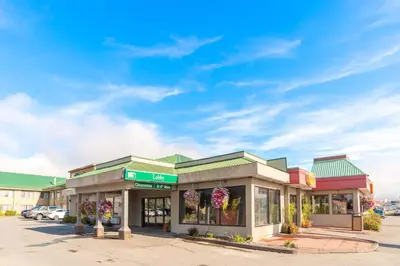 a store front with flowers in a parking lot at Sandman Hotel Cranbrook in Cranbrook