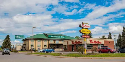a fast food restaurant with a sign in a parking lot at Sandman Inn Smithers in Smithers