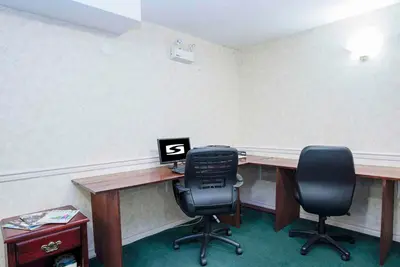 an office with a desk with two chairs and a computer at Sandman Inn Smithers in Smithers