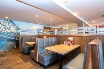 a restaurant on a yacht with a table and chairs at Sandman Hotel Terrace in Terrace
