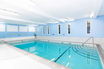 a large swimming pool with blue walls and a large swimming pool at Sandman Hotel Terrace in Terrace