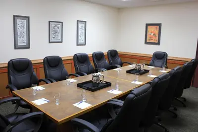 a conference room with a large table and chairs at Quality Hotel & Conference Centre in Peace River