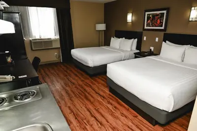 a hotel room with two beds and a sink at Quality Hotel & Conference Centre in Peace River