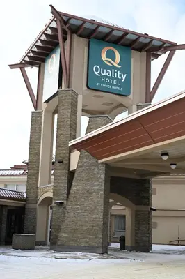a building with a sign for a quality motel at Quality Hotel & Conference Centre in Peace River