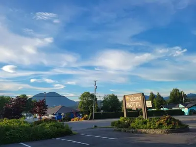 a sign in a parking lot next to a motel at Schooner Motel in Tofino