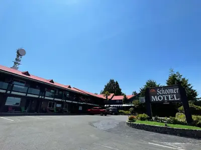 a sign for a motel in front of a building at Schooner Motel in Tofino