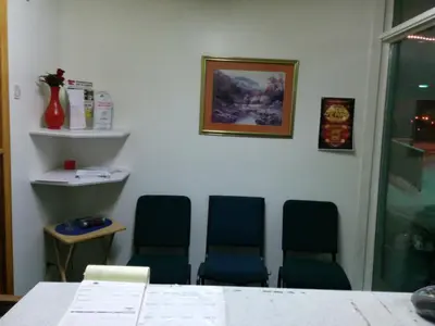 a waiting room with three chairs and a table at Shamrock Motel in Valleyview