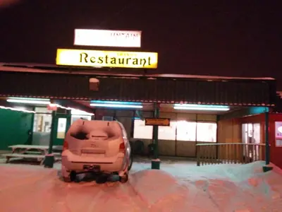a car parked in front of a gas station at Shamrock Motel in Valleyview