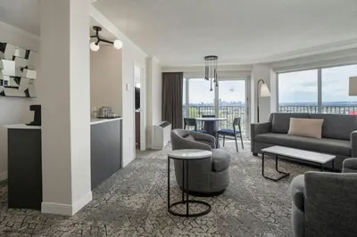 a living room with a couch and a table at Sheraton Cavalier Calgary Hotel in Calgary