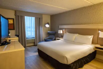 a hotel room with a large bed and a television at Radisson Hotel Fort St John in Fort Saint John