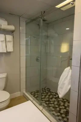 a glass shower in a bathroom with a toilet at Radisson Hotel Fort St John in Fort Saint John