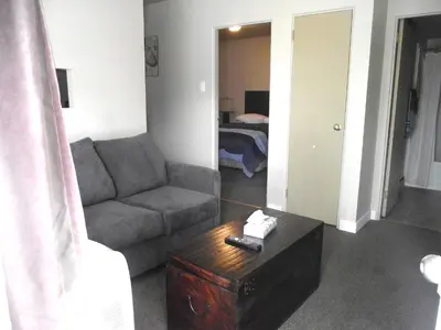 a living room with a couch and a coffee table at Stratford Motel in Whitehorse