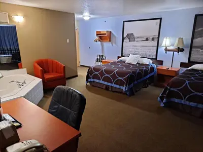 a hotel room with two beds and a bathroom at Super 8 by Wyndham Three Hills AB in Three Hills