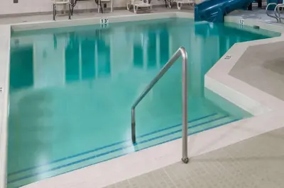 a large swimming pool with a hand rail in it at Super 8 by Wyndham Vermilion AB in Vermilion