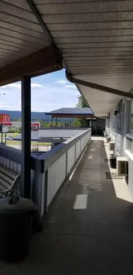 a building with benches and tables on the outside at Howard Johnson by Wyndham Hinton in Hinton