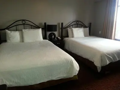 a hotel room with two beds with white sheets at Barclay Hotel in Vancouver