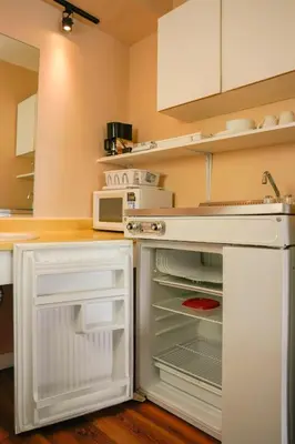 a kitchen with an open refrigerator and a microwave at Thunderbird Motor Inn in Duncan