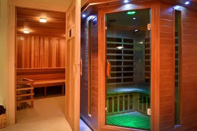 a walk in shower with a glass door at Tyax Lodge & Heliskiing in Gold Bridge