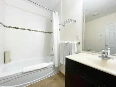 a white bathroom with a tub and a sink at Valhalla Inn in New Denver