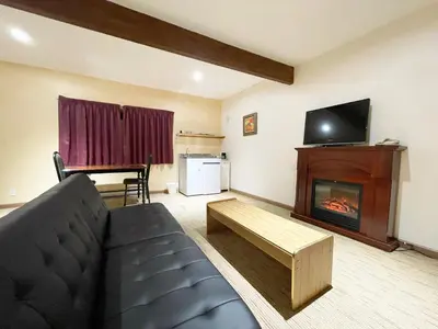 a living room with a couch and a fireplace at Valhalla Inn in New Denver