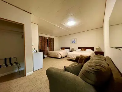 a living room with a couch and a bed at Valhalla Inn in New Denver