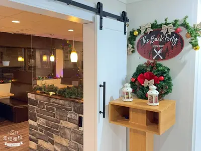a door to a restaurant with a christmas sign at Wells Gray Inn in Clearwater