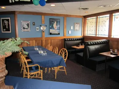 a dining room with a blue table and chairs at Wells Gray Inn in Clearwater