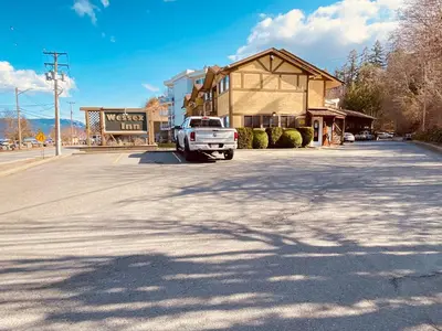 a white truck parked in front of a building at Wessex Inn By The Sea in Cowichan Bay