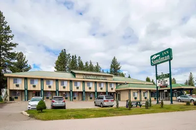 a large building with cars parked in a parking lot at Sandman Inn Princeton in Princeton