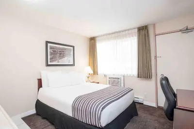 a hotel room with a large bed and a window at Sandman Inn Princeton in Princeton