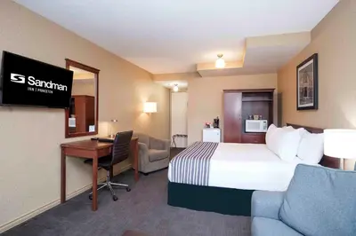 a hotel room with a bed and a desk at Sandman Inn Princeton in Princeton