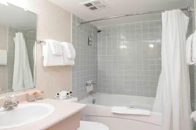 a bathroom with a sink and a tub and a toilet at Sandman Inn Princeton in Princeton