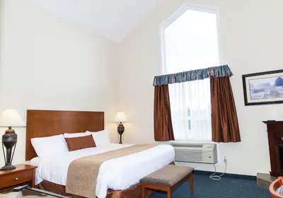 a hotel room with a bed and a window at Hinton Lodge in Hinton