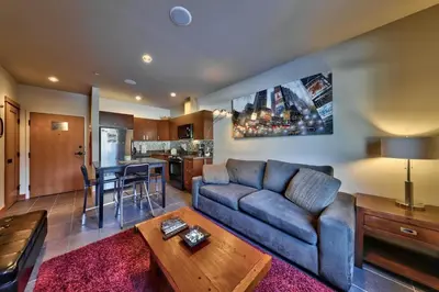 a living room with a couch and a table at Kookaburra Lodge #202 By Bear Country in Sun Peaks