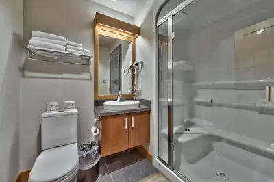 a bathroom with a shower toilet and a sink at Kookaburra Lodge #202 By Bear Country in Sun Peaks